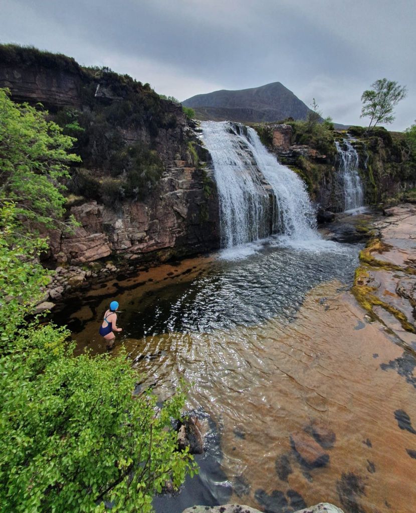 Hayley Crawshaw wild swimming in a waterfall pool in Scotland